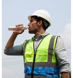construction worker wearing a vest drinking water