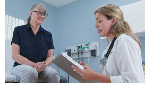 female patient talking to her primary care physician